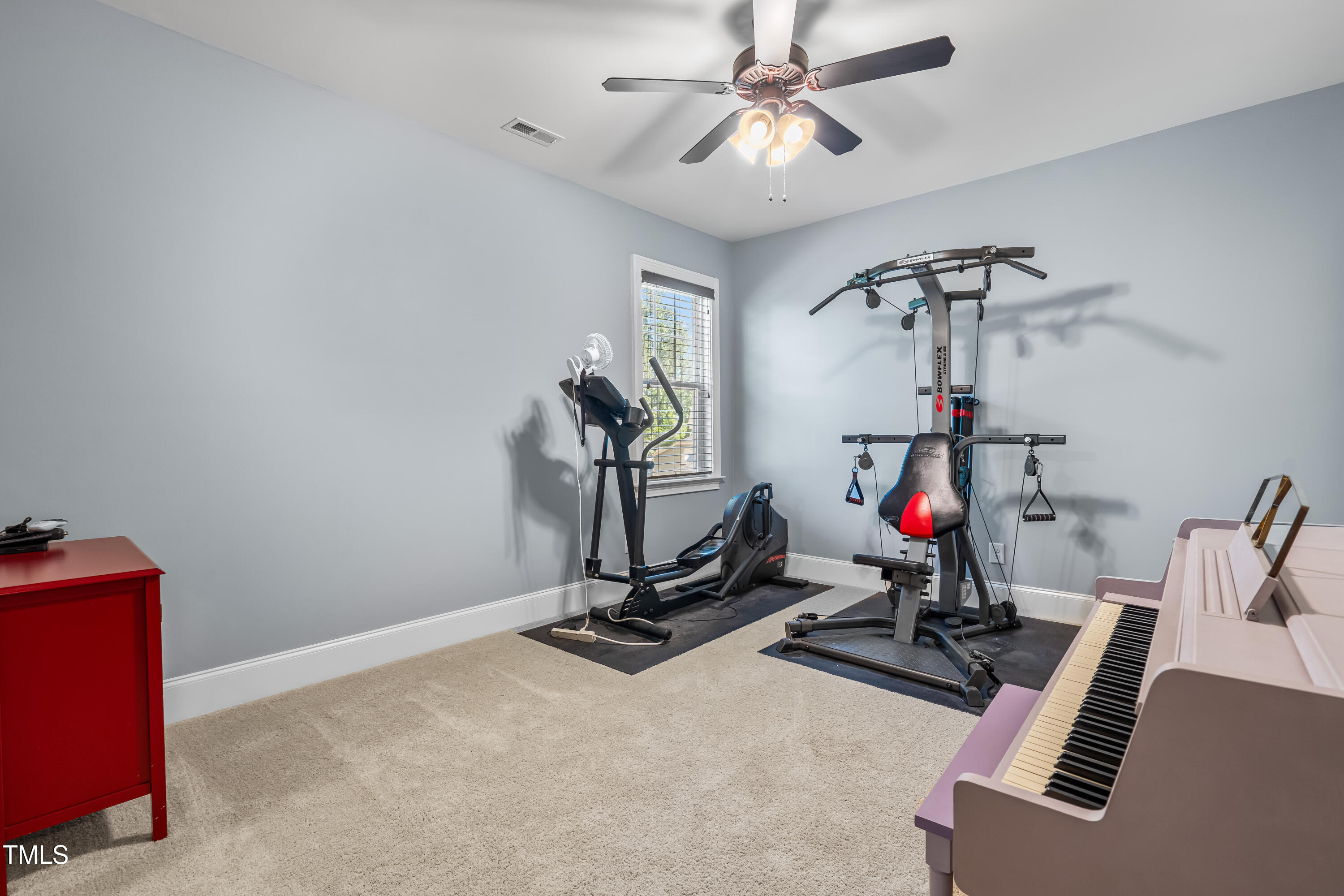 2538 Tuffeto Apex, NC 27502 - Photo 47 of 55 a room with gym equipment and windows