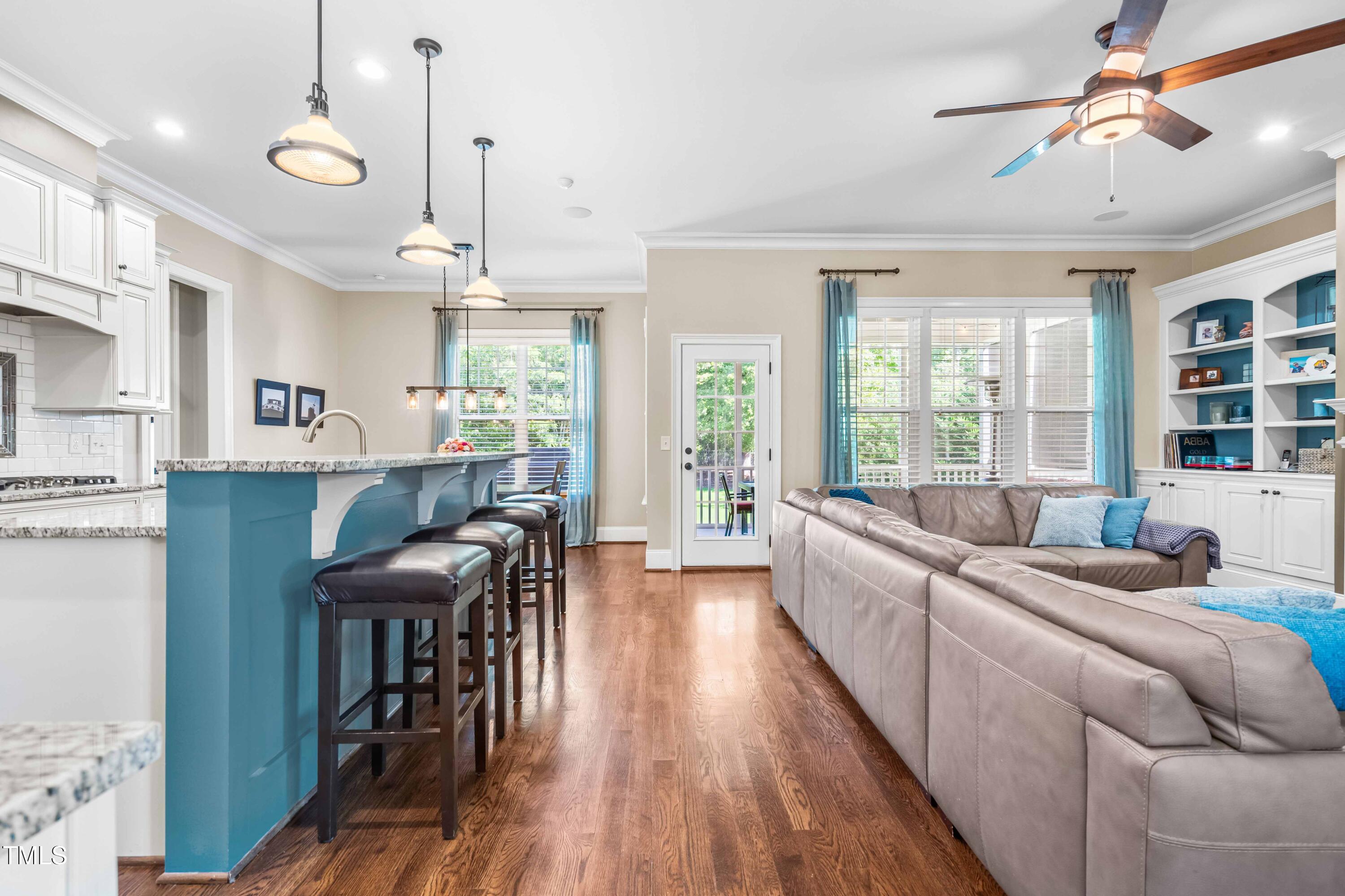2538 Tuffeto Apex, NC 27502 - Photo 9 of 55 a living room with furniture a large window and wooden floor
