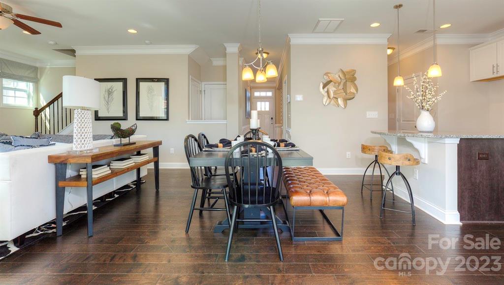 679 Fox Cove Road Hendersonville, NC 28792 - Photo 11 of 35 a view of a dining room with furniture and wooden floor