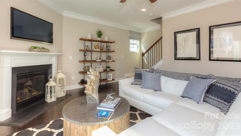 679 Fox Cove Road Hendersonville, NC 28792 - Photo 16 of 35 a living room with furniture a flat screen tv and a fireplace