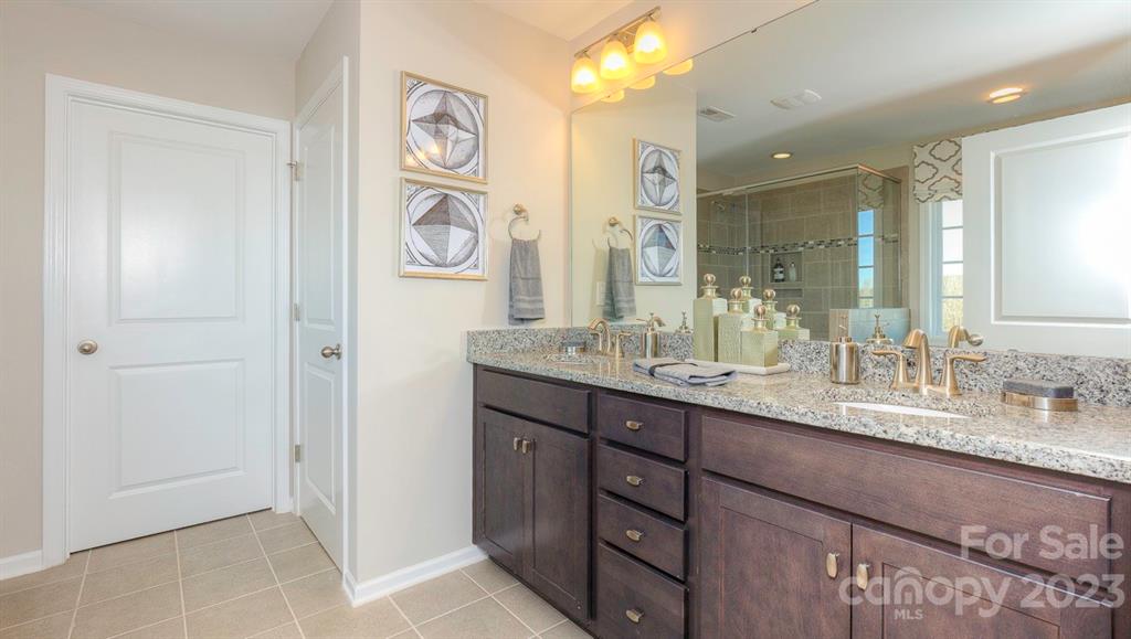 679 Fox Cove Road Hendersonville, NC 28792 - Photo 27 of 35 a bathroom with double vanity sinks and a mirror