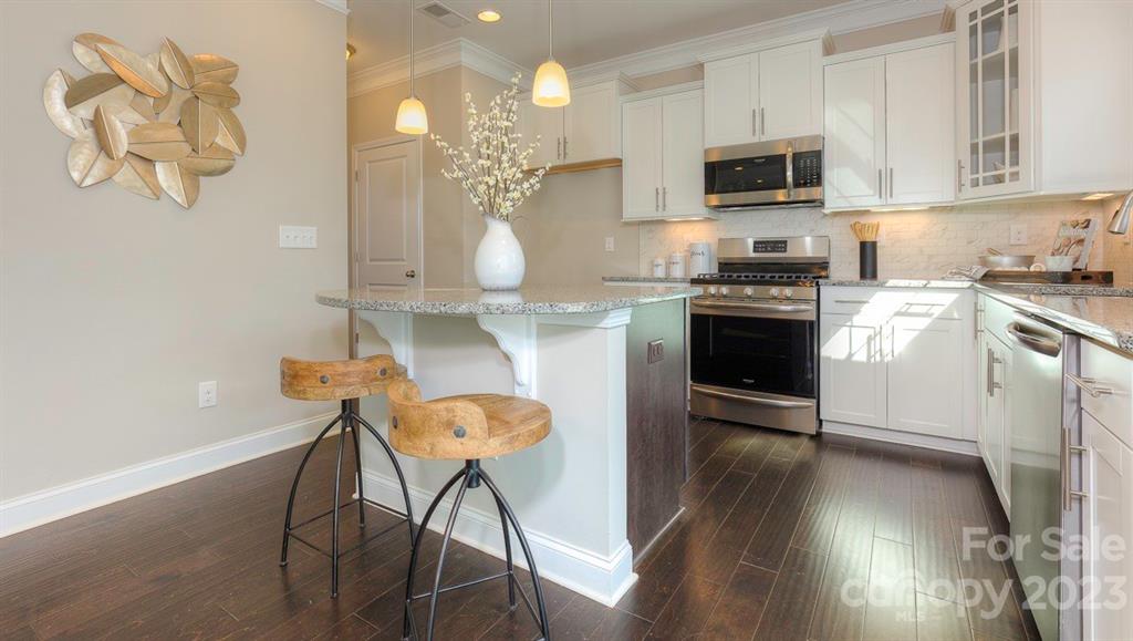 679 Fox Cove Road Hendersonville, NC 28792 - Photo 8 of 35 a kitchen with stainless steel appliances a stove a sink and a microwave