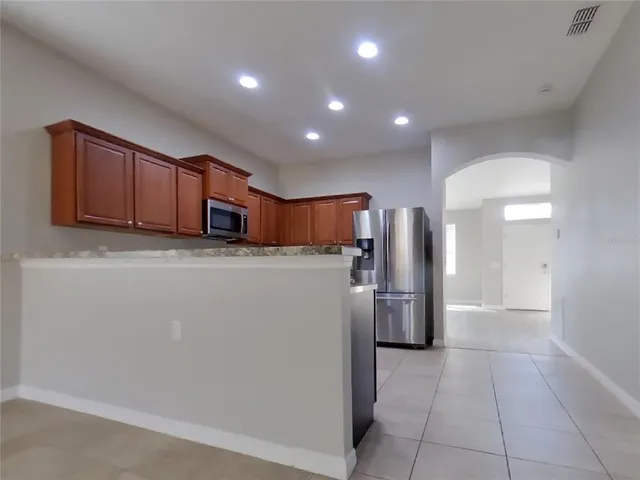 a kitchen with refrigerator and cabinets