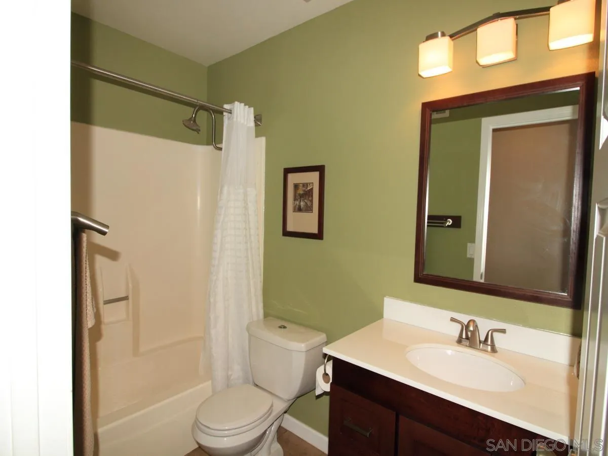 13414 Racquet Court Poway, CA 92064 - Photo 8 of 29 a bathroom with a sink vanity mirror and toilet