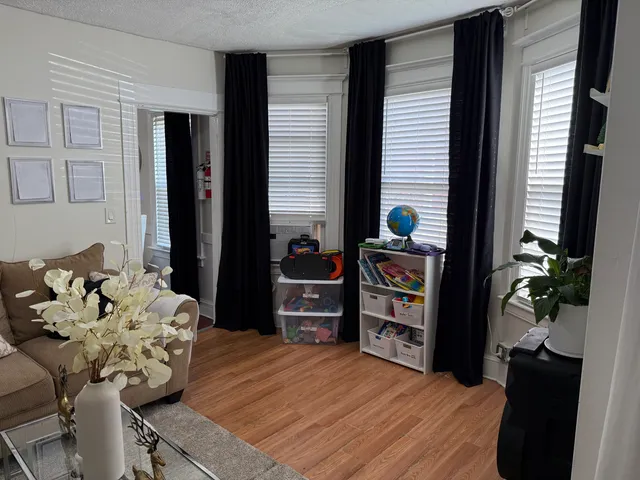a large bed sitting in a bedroom next to a window