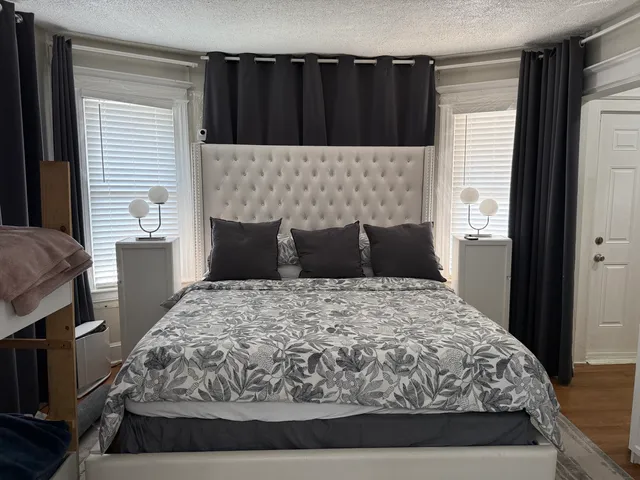 a bed room with a bed and a television