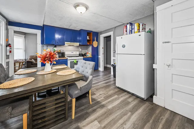 a kitchen with furniture and wooden floor