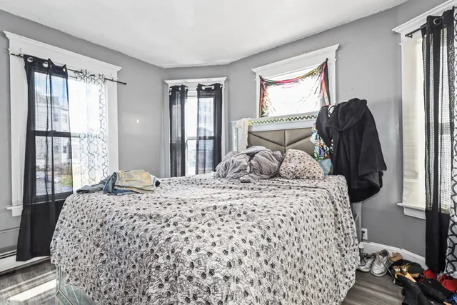 a bed room with two bed and a dresser