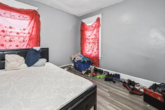 a bedroom with a bed and a large window