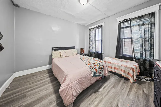 a kitchen with stainless steel appliances granite countertop a refrigerator a stove and white countertops with wooden floor