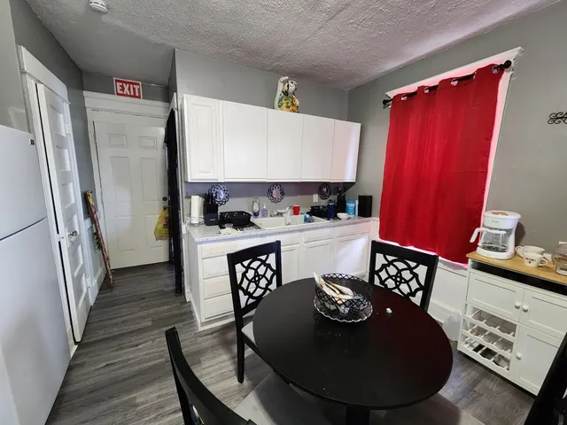 a kitchen that has a lot of cabinets a sink and a stove in it