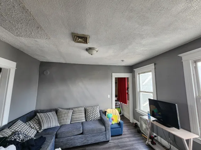 a view of a livingroom with furniture hardwood floor and a window
