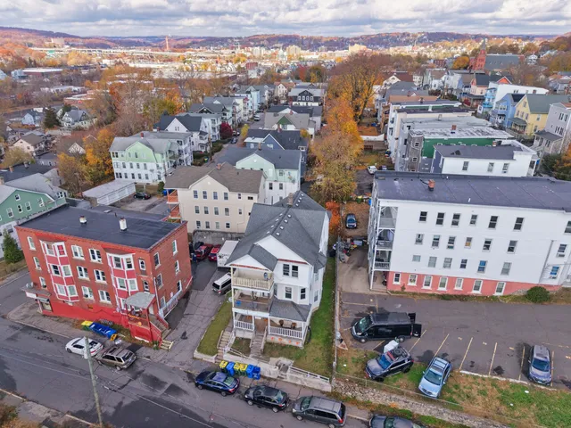 a kitchen with stainless steel appliances a stove a refrigerator and a fireplace
