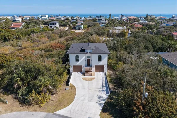 an aerial view of a house with yard