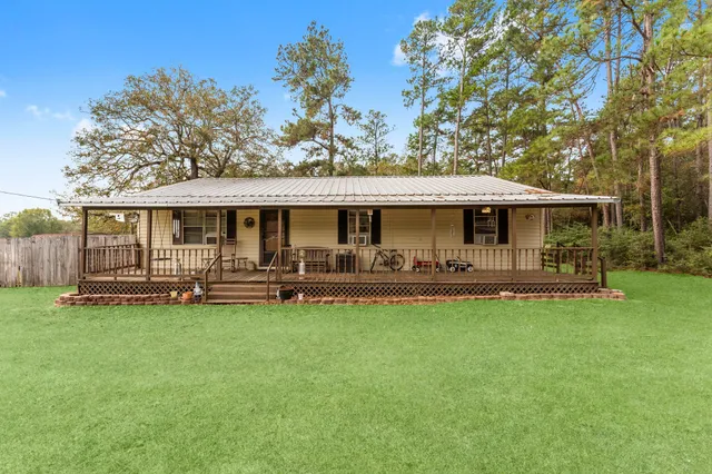 a front view of a house with swimming pool having outdoor seating
