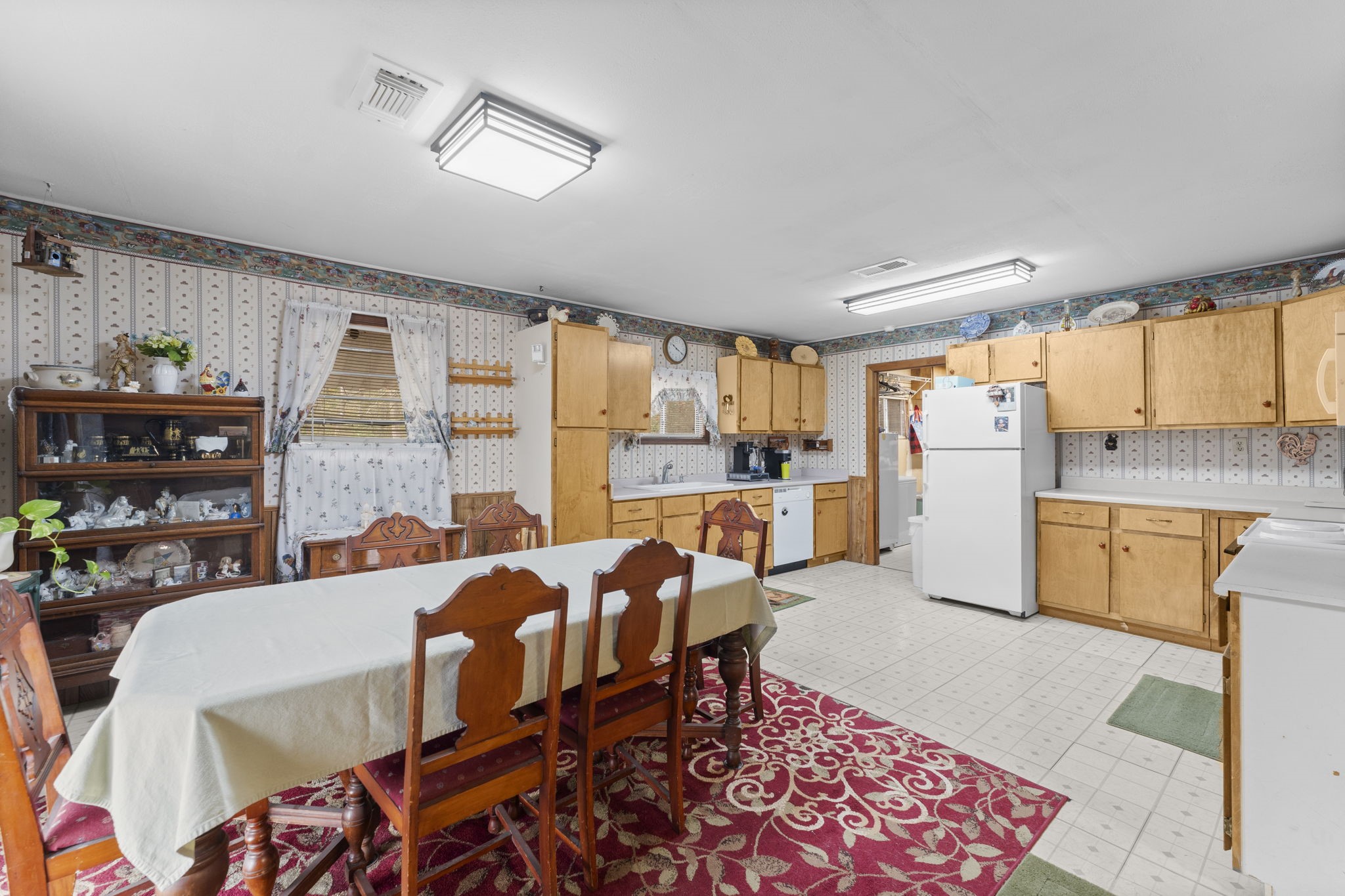 11281 Clint Parker Road Conroe, TX 77303 - Photo 11 of 32 a open kitchen with stainless steel appliances granite countertop a stove a refrigerator a dining table and chairs with wooden floor