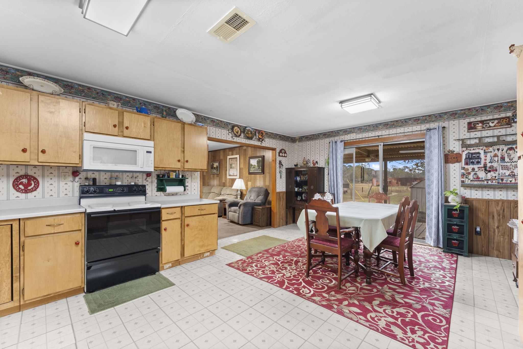 11281 Clint Parker Road Conroe, TX 77303 - Photo 12 of 32 a kitchen with a dining table and chairs with wooden floor