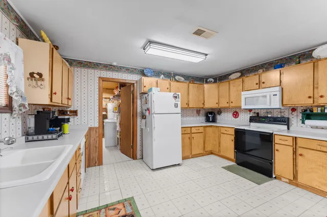 a kitchen with a refrigerator a sink and cabinets