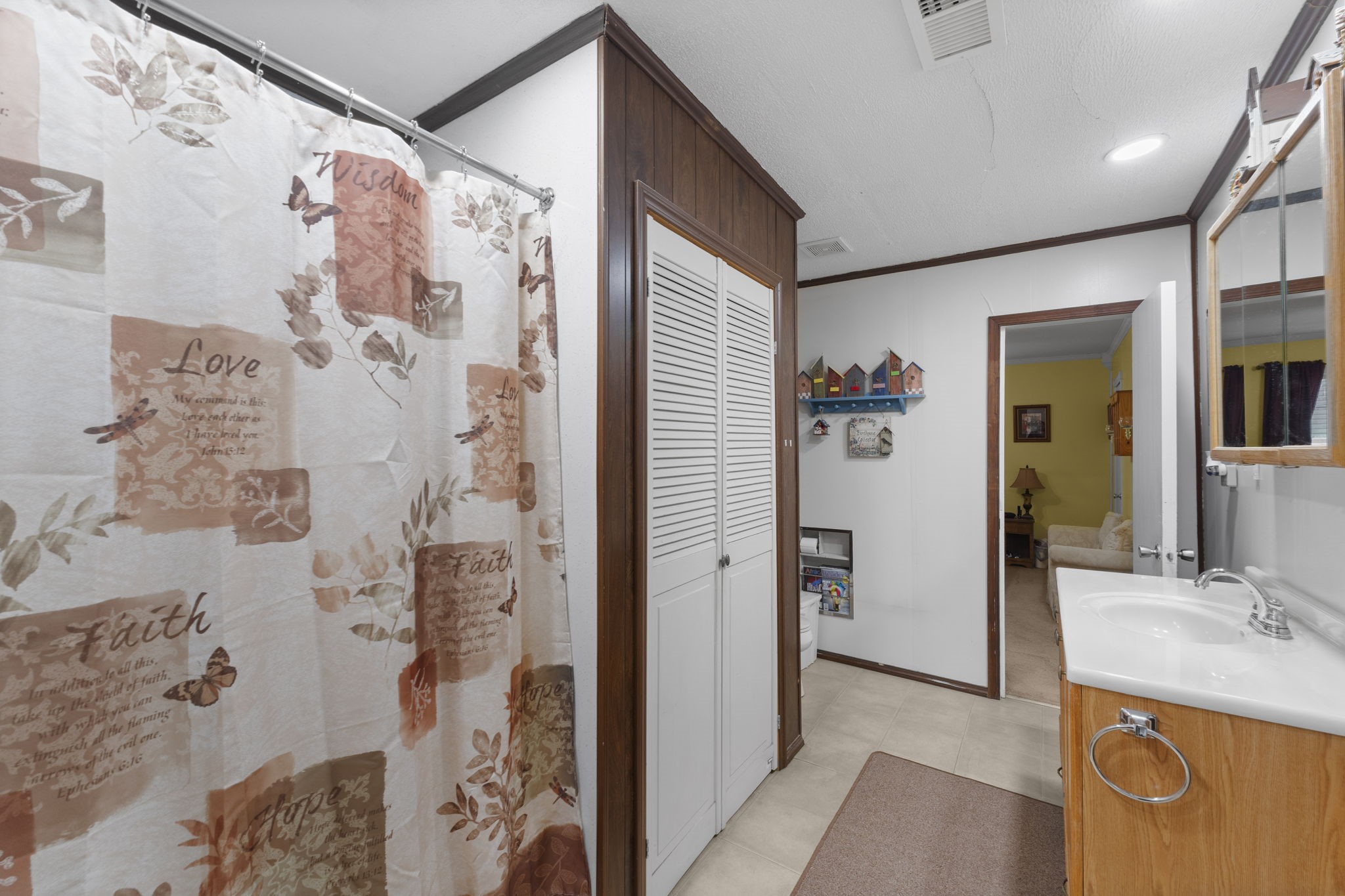 11281 Clint Parker Road Conroe, TX 77303 - Photo 17 of 32 a bathroom with a granite countertop shower sink and mirror