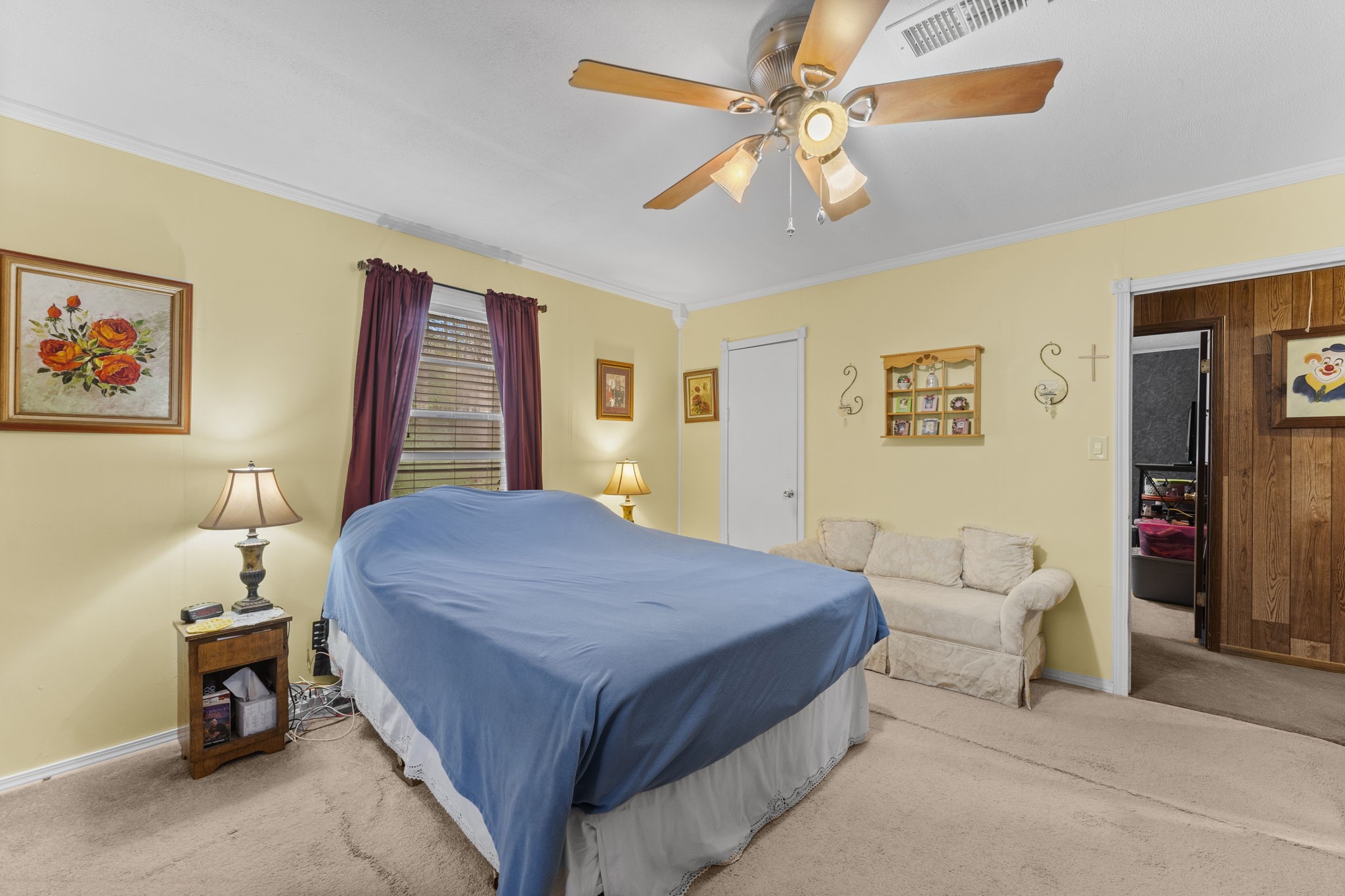 11281 Clint Parker Road Conroe, TX 77303 - Photo 20 of 32 a bedroom with a bed and a chandelier