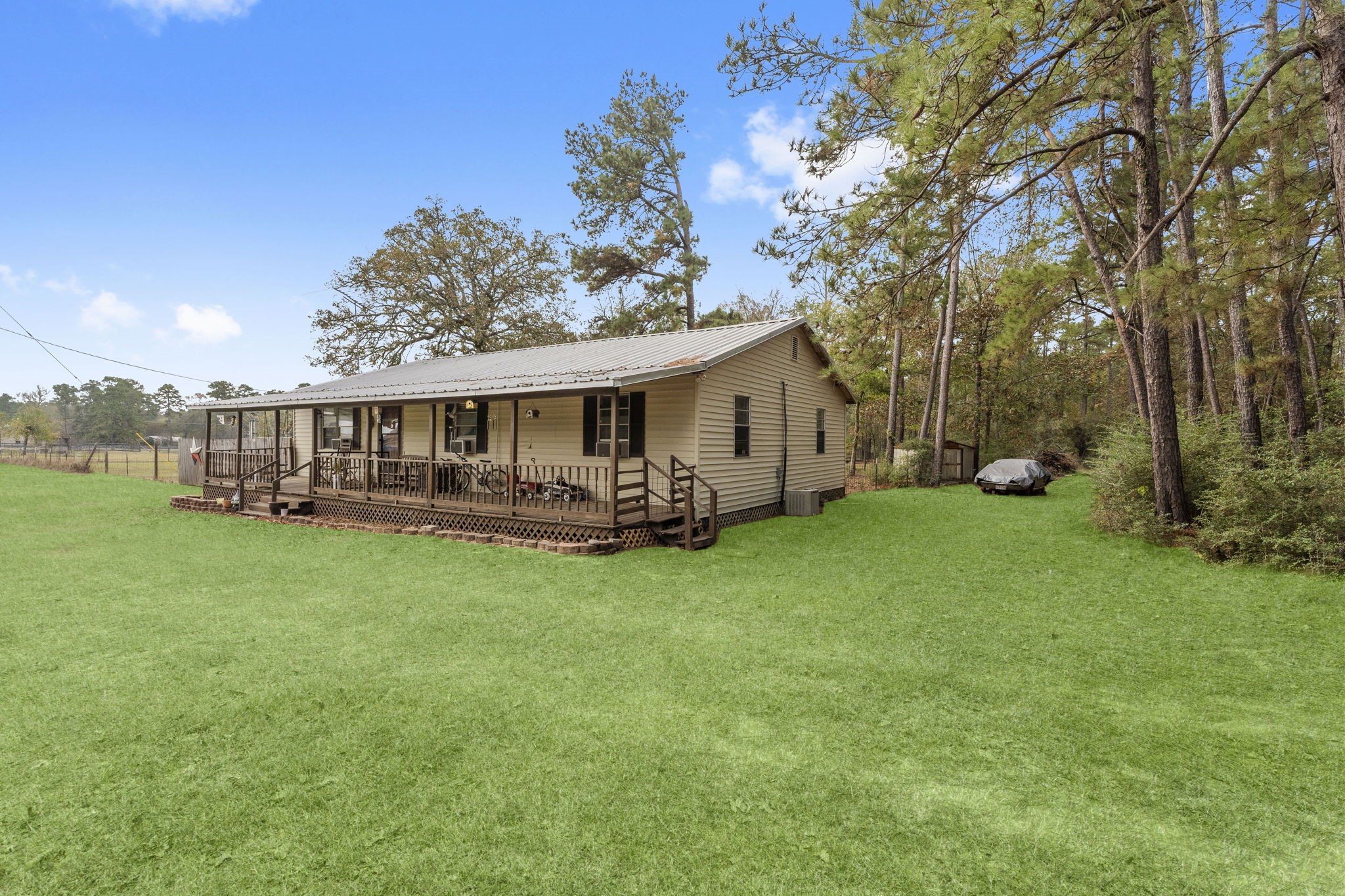 11281 Clint Parker Road Conroe, TX 77303 - Photo 2 of 32 a view of a house with backyard porch and garden