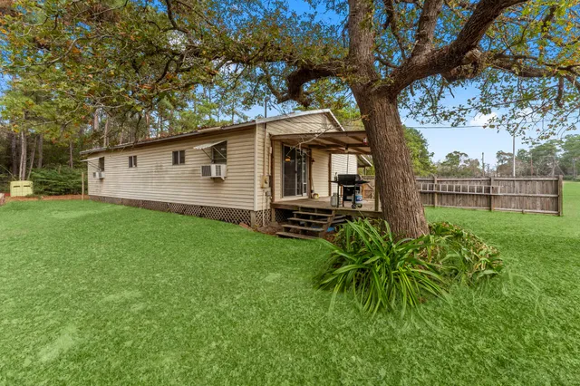 a view of a house with a backyard