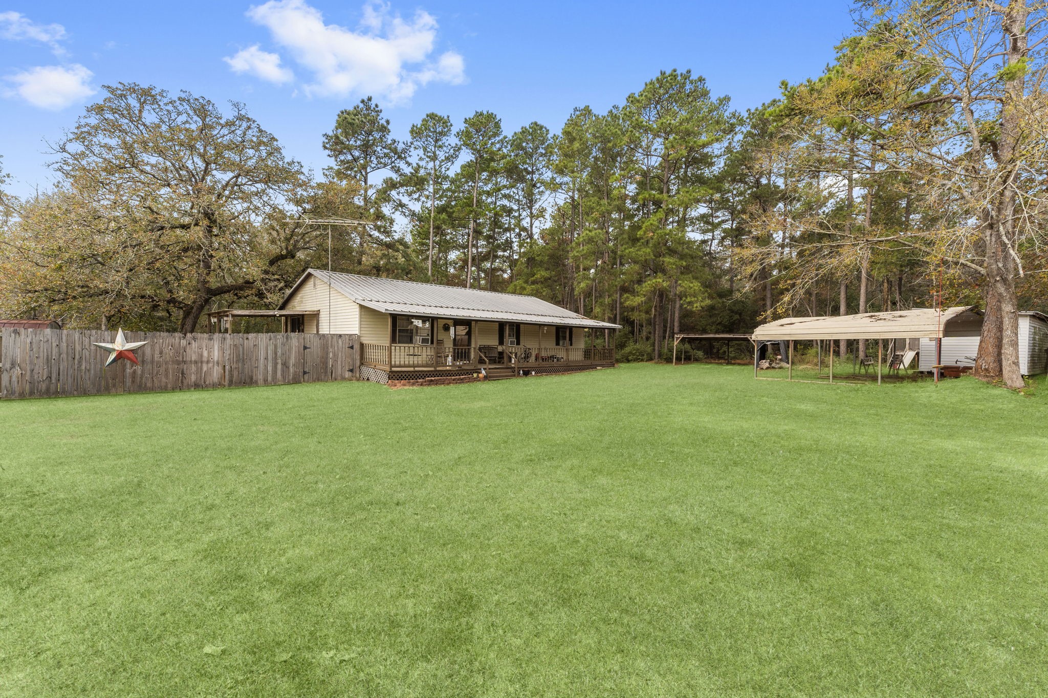 11281 Clint Parker Road Conroe, TX 77303 - Photo 30 of 32 a yellow and red house with a big yard and large trees