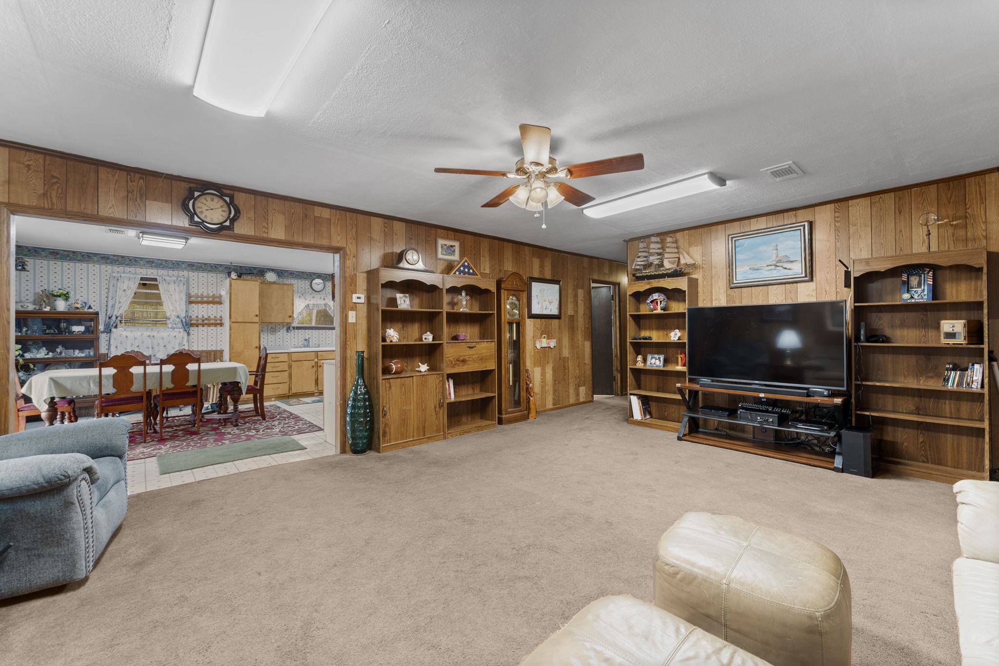 11281 Clint Parker Road Conroe, TX 77303 - Photo 9 of 32 a living room with furniture and a flat screen tv