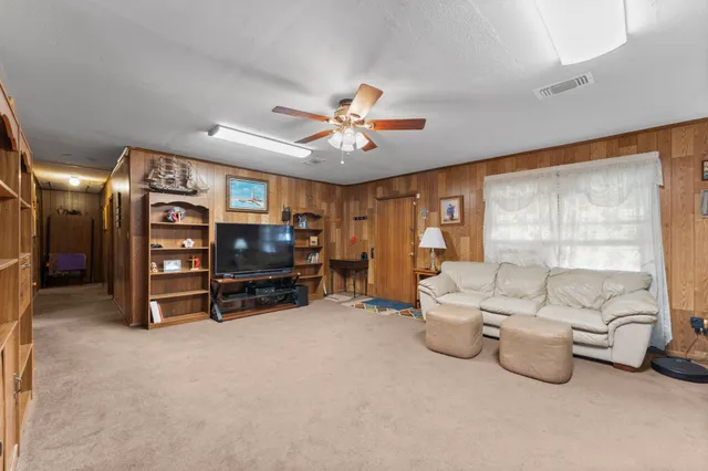 a living room with furniture gym equipment and a large window