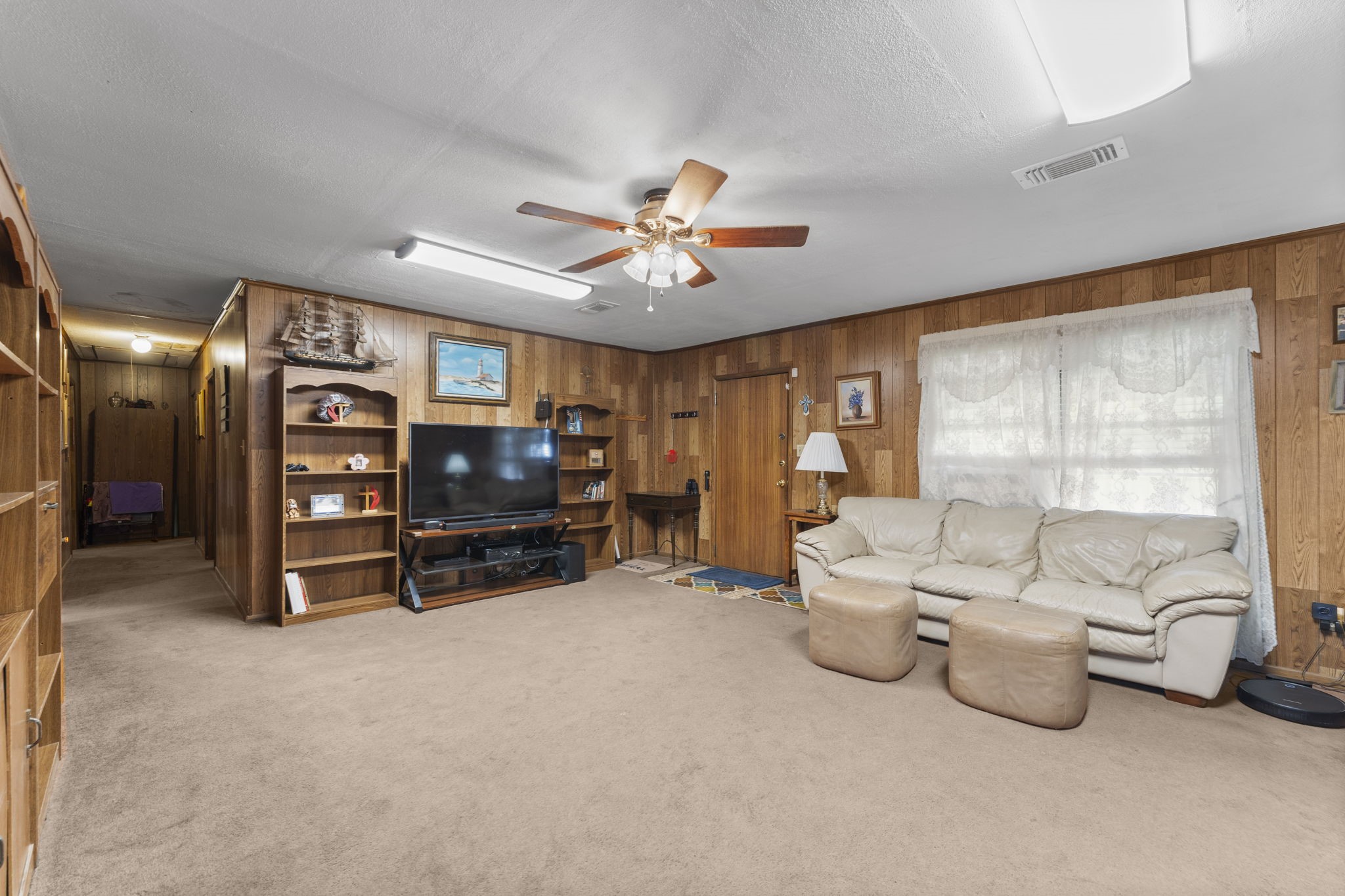 11281 Clint Parker Road Conroe, TX 77303 - Photo 10 of 32 a living room with furniture gym equipment and a large window
