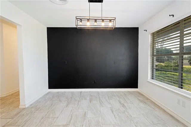 a view of a livingroom with wooden floor and a window