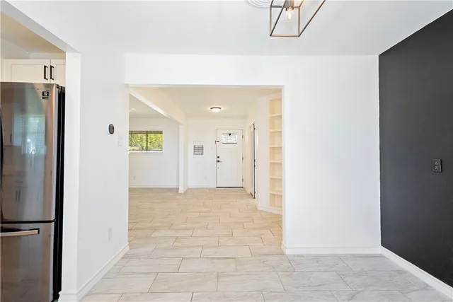 a view of a hallway with wooden cabinets