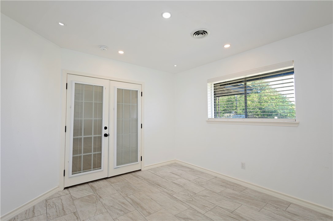 7629 Lang Road Portland, TX 78374 - Photo 16 of 36 an empty room with wooden floor and windows