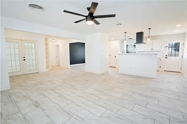 a view of a kitchen with a sink and a refrigerator