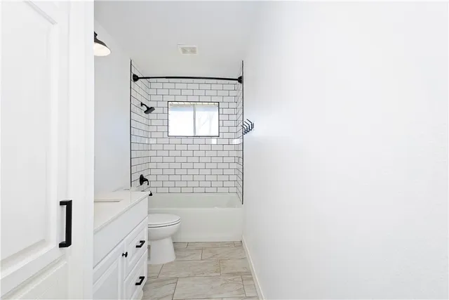 a bathroom with a toilet a sink and shower