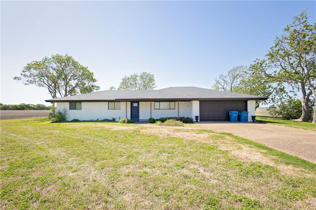 7629 Lang Road Portland, TX 78374 - Photo 2 of 36 a front view of a house with a yard and trees