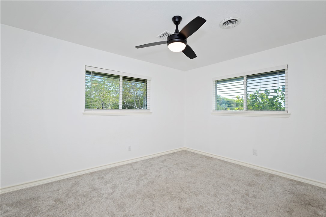 7629 Lang Road Portland, TX 78374 - Photo 21 of 36 an empty room with a window and a fan