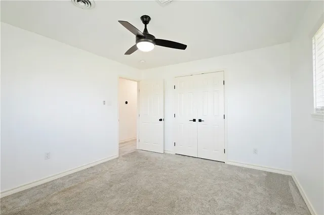 a view of a room with a ceiling fan