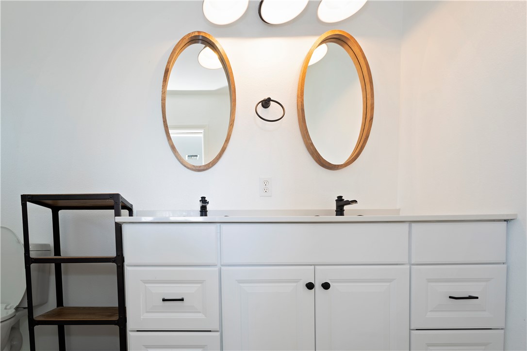 7629 Lang Road Portland, TX 78374 - Photo 25 of 36 a bathroom with a sink and a mirror