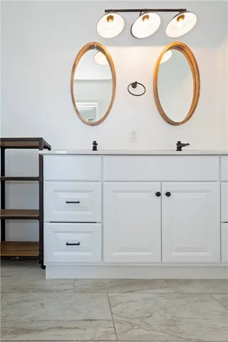 a bathroom with a sink mirror and vanity