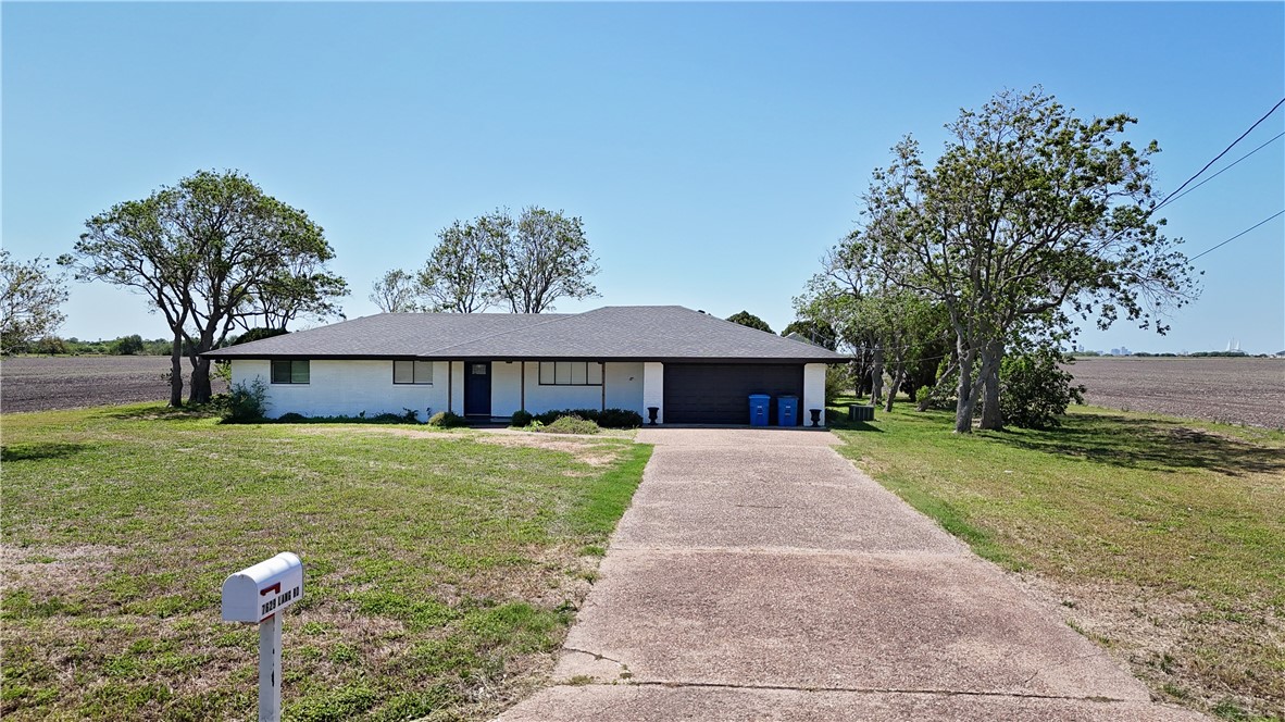 7629 Lang Road Portland, TX 78374 - Photo 33 of 36 a front view of a house with garden