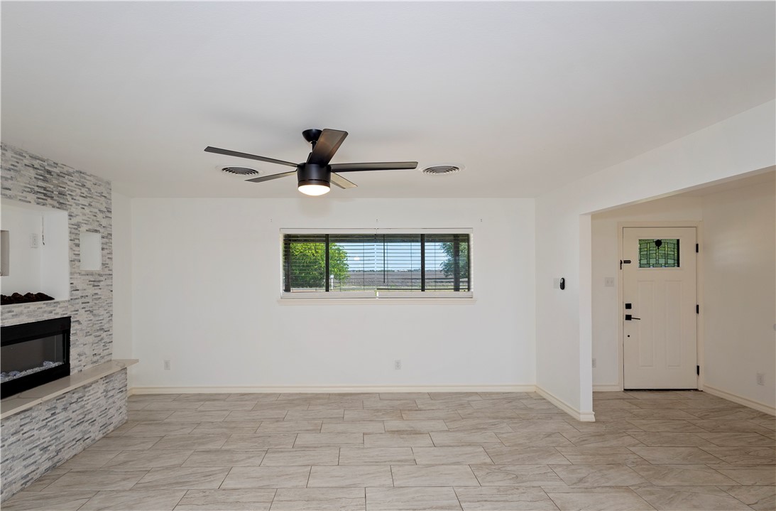 7629 Lang Road Portland, TX 78374 - Photo 5 of 36 a view of a livingroom with a ceiling fan and window