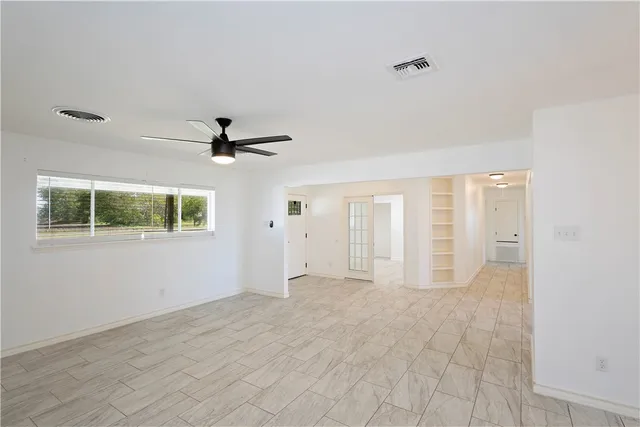 a view of an empty room with a window