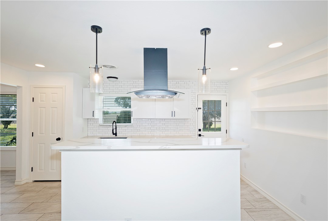 7629 Lang Road Portland, TX 78374 - Photo 7 of 36 a kitchen with kitchen island stainless steel appliances a sink and cabinets