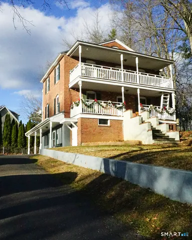 a front view of a building with a garden