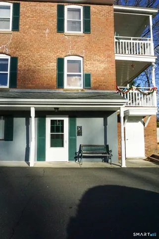 a view of a building with chair and tables
