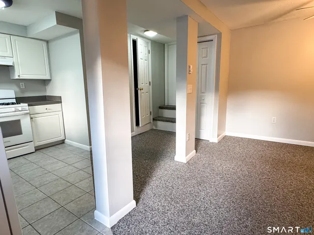 a view of a kitchen with a sink and a refrigerator