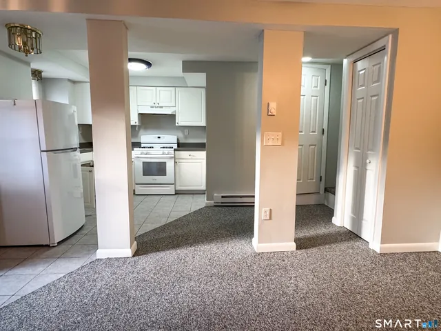 a white kitchen with sink and white stainless steel appliances