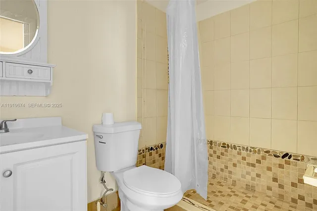 a white toilet sitting next to a bathroom sink