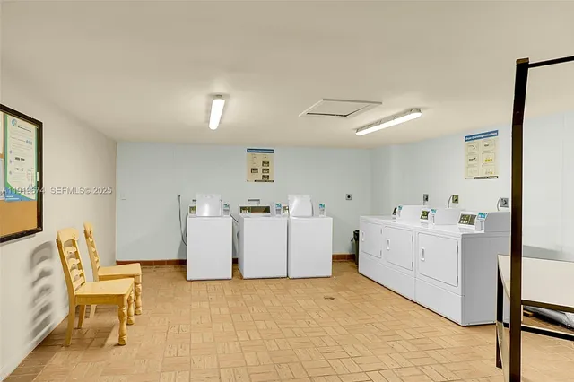 a utility room with cabinets dryer and washer